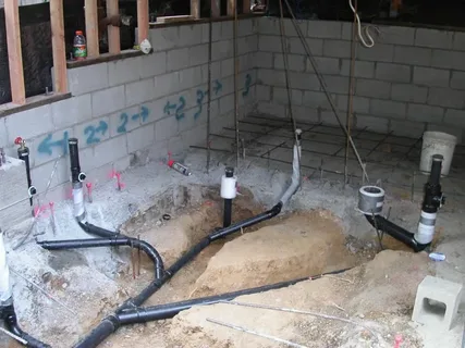 A complex underground basement plumbing drainage system being installed by Prime Plumbing Services, the leading basement plumbing contractors Edmonton.